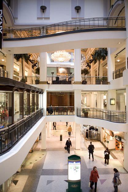 people are walking around in the mall with chandeliers