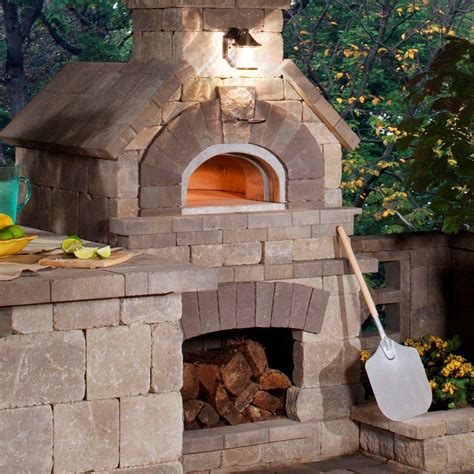 an outdoor brick oven with a shovel next to it