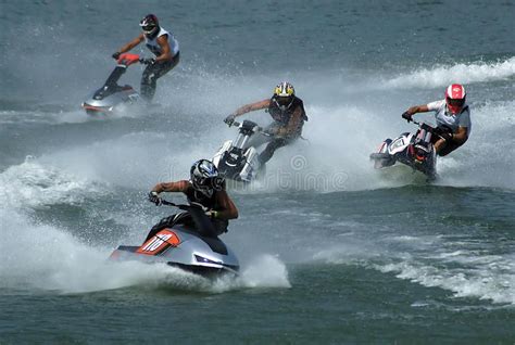 four people are riding jet skis in the water