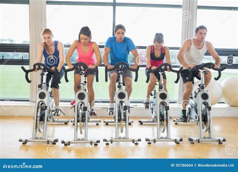 Determined People Working Out At Spinning Class In Gym Stock Images ...