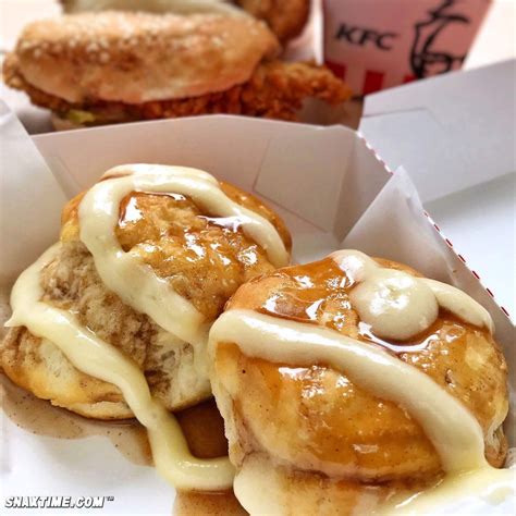 two donuts covered in icing sitting on top of a white paper wrapper