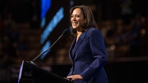 Download Kamala Harris Smile Onstage Wallpaper | Wallpapers.com