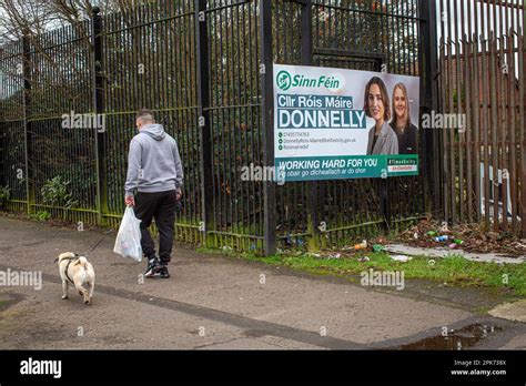 A man walks past an election poster showing Sinn Fein Councillor Róis ...