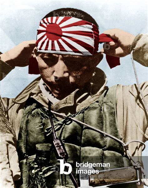 Japanese kamikaze putting on his forehead bandeau with rising sun ...