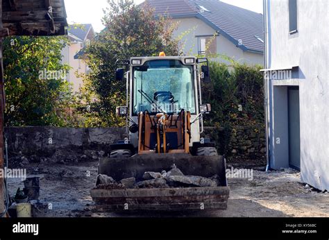 Digger machine on building construction site Stock Photo - Alamy