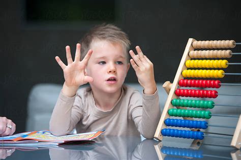 "Young Boy Counting On Fingers" by Stocksy Contributor "Lee Avison ...