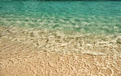 Premium Photo | Wavy water background on sand