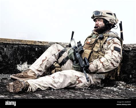 U. S. Navy SEAL infantryman, commando marksman in battle uniform, armed ...