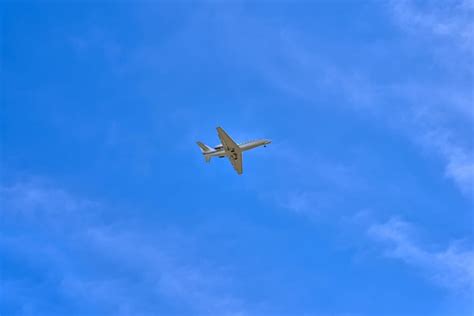 Premium Photo | Small private jet landing or taking off on blue sky