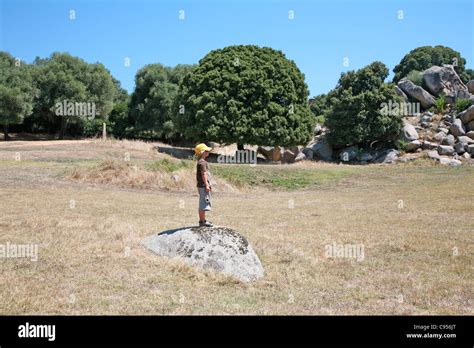 Boy on a rock Stock Photo - Alamy