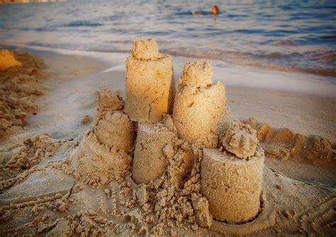 Sand castle on the beach stock photo. Image of playing - 107232892