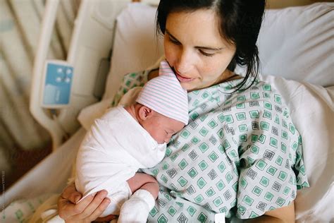 "Mother Holds Newborn Baby In Hospital Bed" by Stocksy Contributor ...