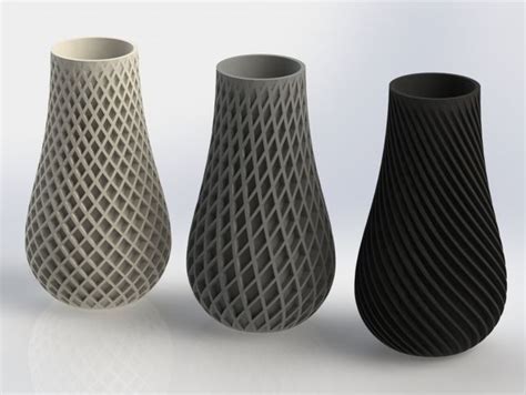 three black and white vases sitting next to each other