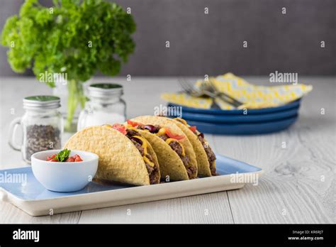 Mexican tacos with beef, cheddar cheese, tomato Stock Photo - Alamy