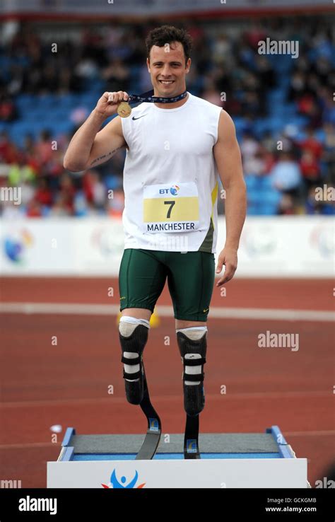 South Africa's Oscar Pistorius poses with his gold medal aftere winning ...