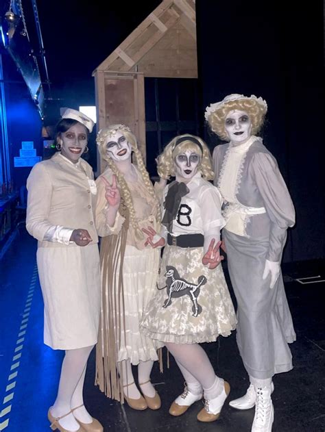 four people dressed in costumes posing for a photo