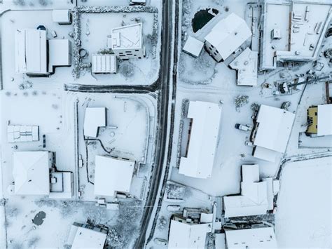 Premium Photo | Aerial view of town with snow covered houses. roof tops ...