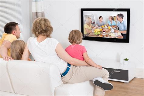 Young Family Watching TV Together Stock Photo by ©AndreyPopov 53301879