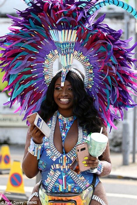 Notting Hill Carnival revellers strut their stuff in sequinned ...