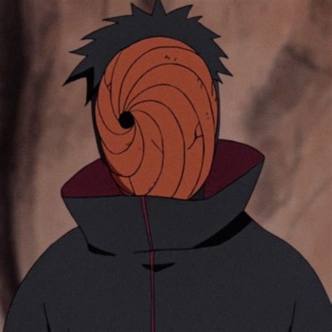 a man in a black hoodie with an orange spiral design on his face and back