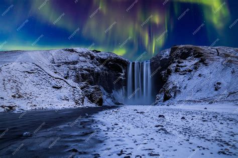 Premium Photo | Skogafoss waterfall in the winter at night under the ...