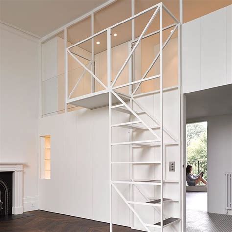 A metal-framed staircase leads to mezzanine floor inside this newly ...