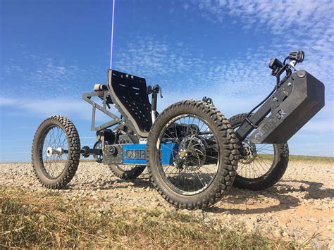 an off - road vehicle is parked in the middle of a field with no wheels