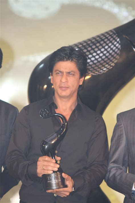 Shah Rukh Khan posing with TOIFA Trophy at the launch of the TIMES OF ...