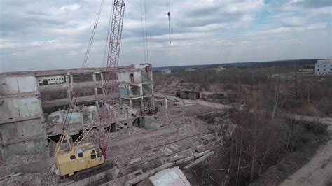 FPV drone flies smoothly among abandoned industrial buildings and ...