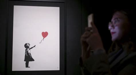 WATCH: Banksy Painting “Girl with Balloon” Self-Destructs After ...