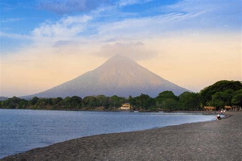 The peak of Concepcion volcano and a black sand beach on Ometepe Island ...