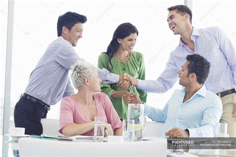 Business people shaking hands in meeting at modern office — partner ...