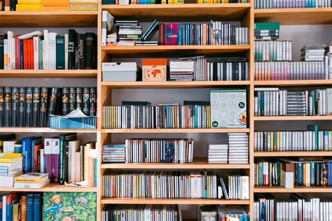 Bookshelf with books and cds, background, bookcase, bookstore wallpaper ...