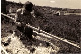  Moise Flamand shaving a snowshoe stave of yellow birch wood with the traditional crooked knife , Manouane P.Q. ; from  ''Making the Attikamek Snowshoe'' ; photo Henri Vaillancourt 1979