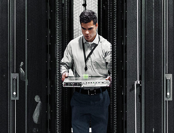 Man installing a server into a server rack