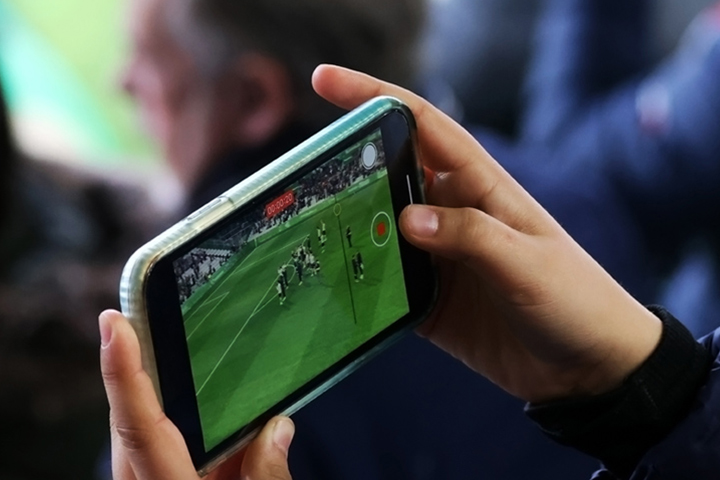 User watching sports on mobile device