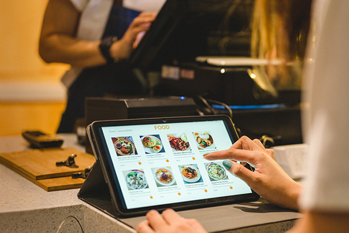 Restaurant customer completing food purchase with a kiosk