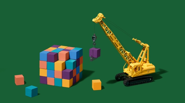 A crane picking up blocks representing building on the Slack platform