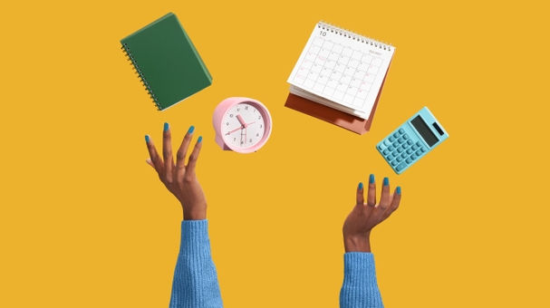 Hands juggling a notepad, clock, calculator and calendar showing productivity