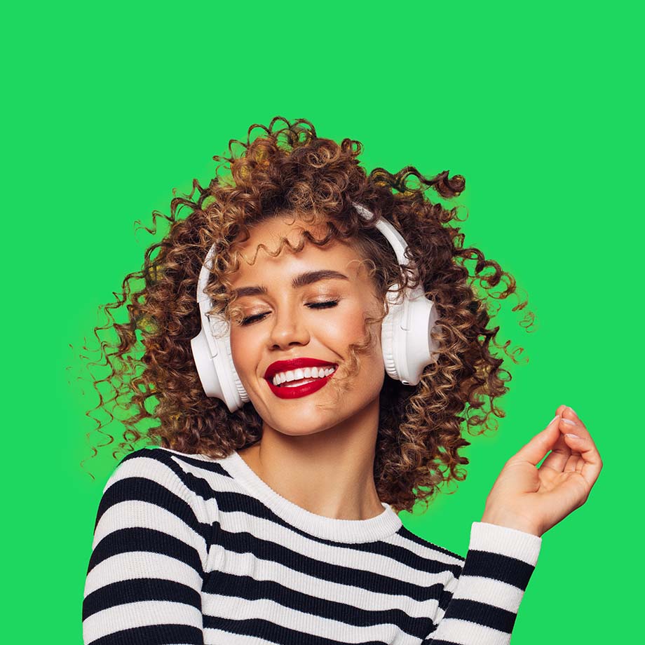 Woman wearing headphones, smiling