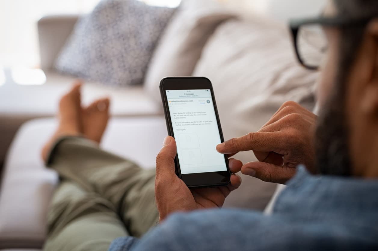 Man using phone on couch