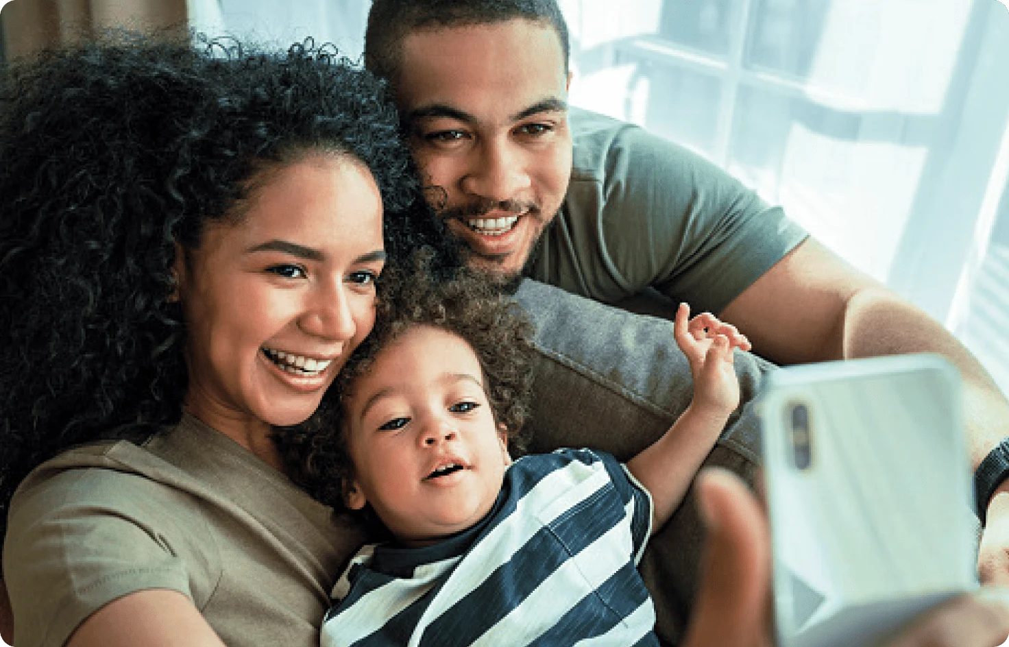 A smiling mother, father and small child