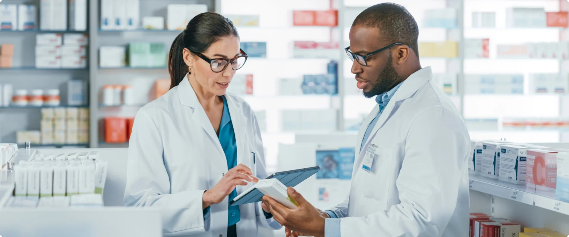 two pharmacists looking at a tablet together