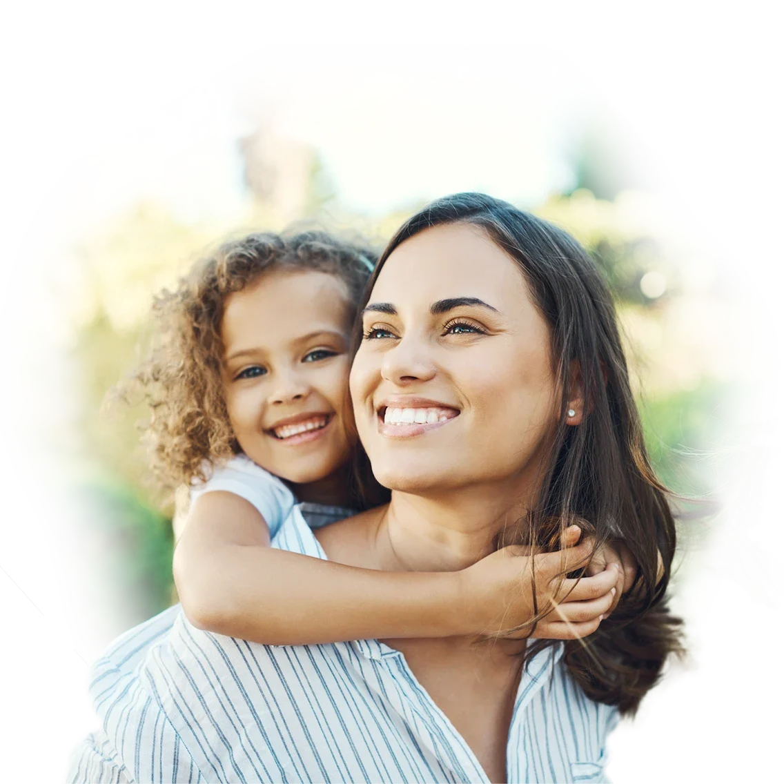 a little girl holding onto a young woman