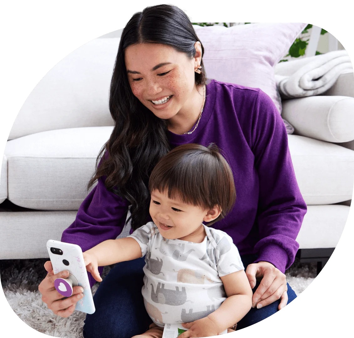 Young mom with her toddler, enjoying a phone chat