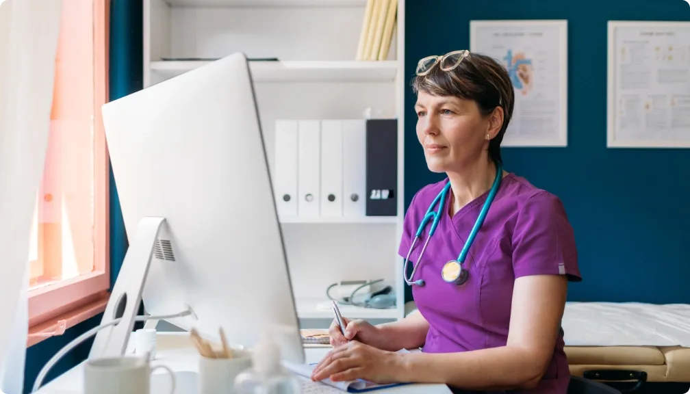 a healthcare practitioner working on her computer.