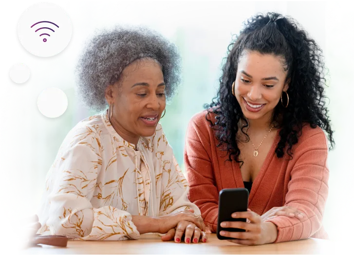 Two women viewing a smartphone together