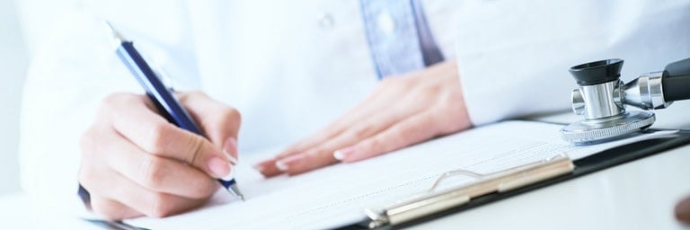 closeup view of doctor writing down health information