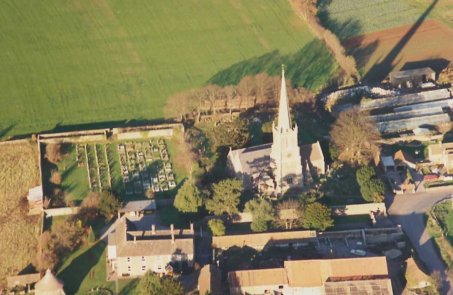 view of church, graveyard and Winterbourne Court from the air