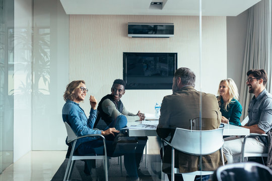 Female manager leads brainstorming meeting in office